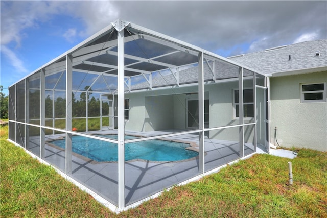 back of property with a lanai and a patio