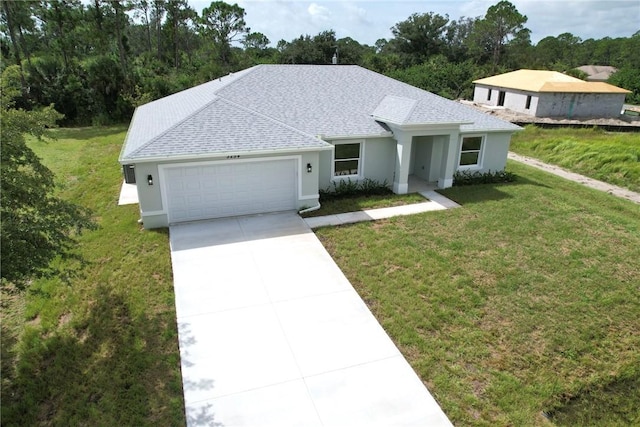 view of front facade with a front lawn and a garage