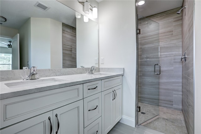 bathroom featuring tile patterned floors, vanity, and an enclosed shower