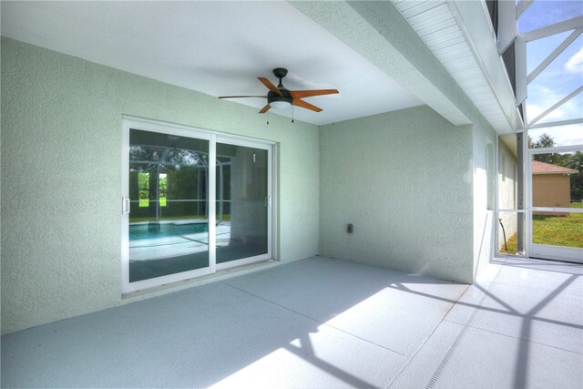 view of patio / terrace with glass enclosure and ceiling fan