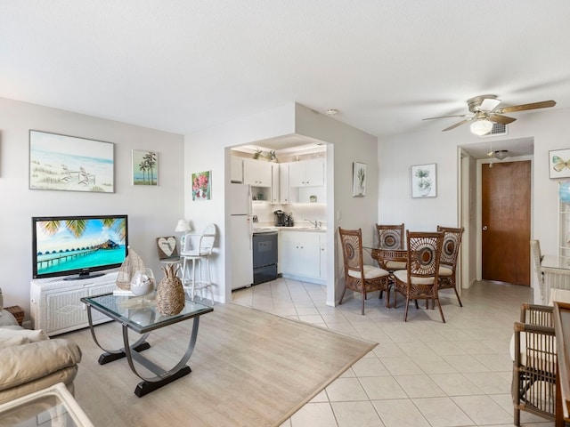 tiled living room featuring ceiling fan, sink, and a textured ceiling