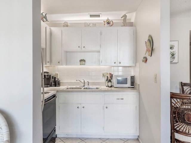 kitchen featuring decorative backsplash, white cabinetry, black / electric stove, and sink