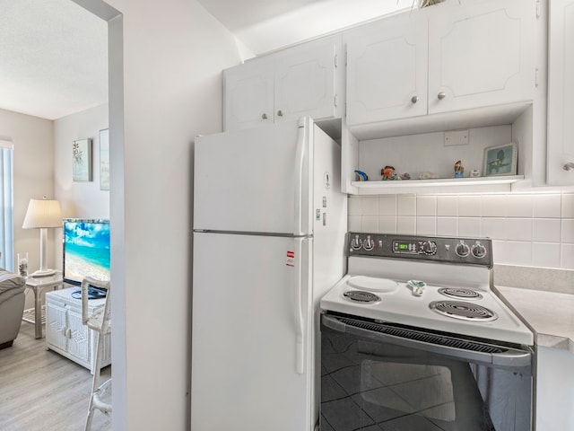 kitchen with white appliances, light hardwood / wood-style flooring, white cabinetry, and tasteful backsplash