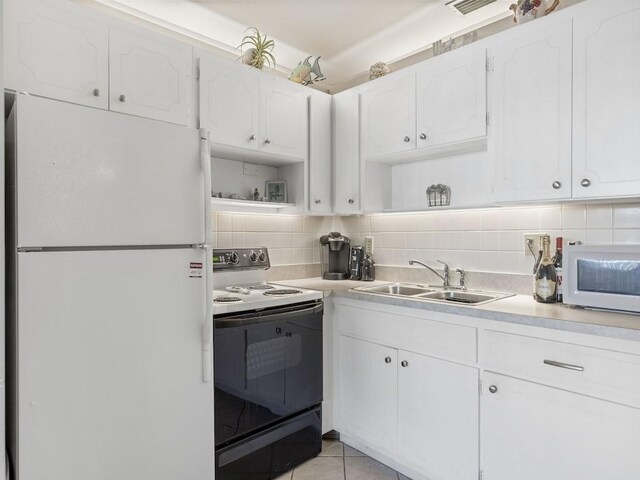 2800 Indian River Blvd Unit N2, Vero Beach, FL 32960 - kitchen with white appliances, open shelves, a sink, and white cabinetry
