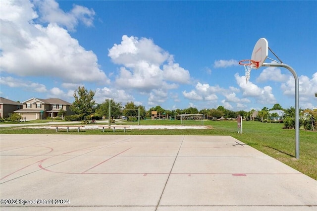 view of basketball court with a lawn