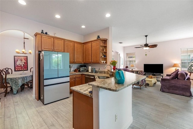 kitchen with kitchen peninsula, a wealth of natural light, sink, and appliances with stainless steel finishes