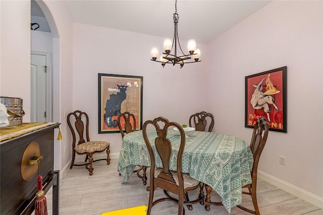 dining space with a notable chandelier and light wood-type flooring