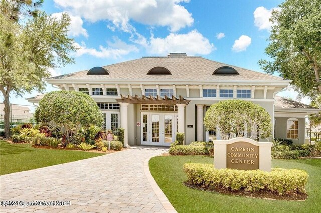 exterior space with a lawn and french doors