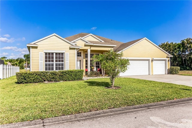 view of front of property with a front yard and a garage