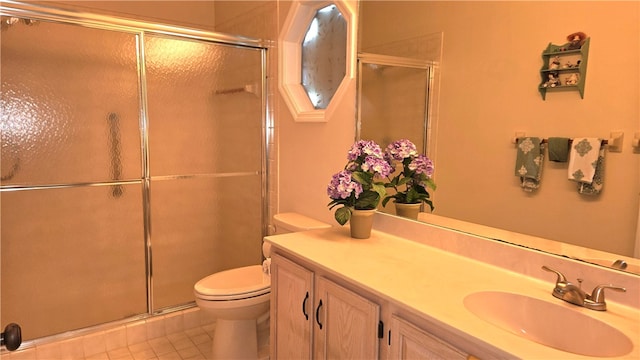 bathroom featuring vanity, tile patterned floors, toilet, and an enclosed shower