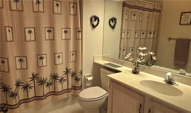 bathroom featuring vanity, tile patterned flooring, and toilet