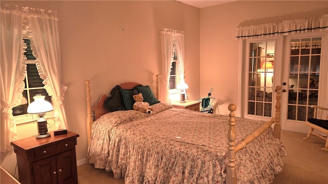 bedroom featuring french doors and carpet