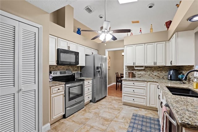 2033 Thistle Dr, Melbourne, FL 32935 - kitchen with a sink, stainless steel appliances, a ceiling fan, lofted ceiling, and tasteful backsplash