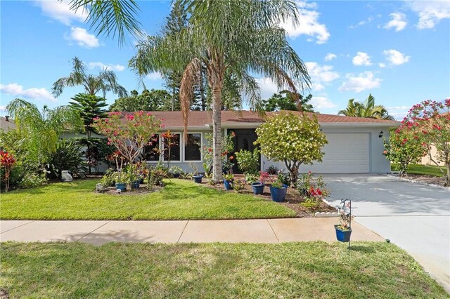 2033 Thistle Dr, Melbourne, FL 32935 - ranch-style home featuring a garage, stucco siding, a front yard, and concrete driveway