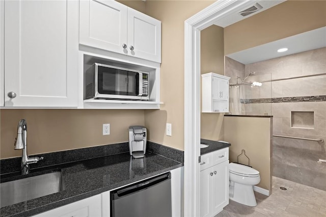 2033 Thistle Dr, Melbourne, FL 32935 - kitchen with a sink, white cabinetry, stainless steel microwave, and dishwasher