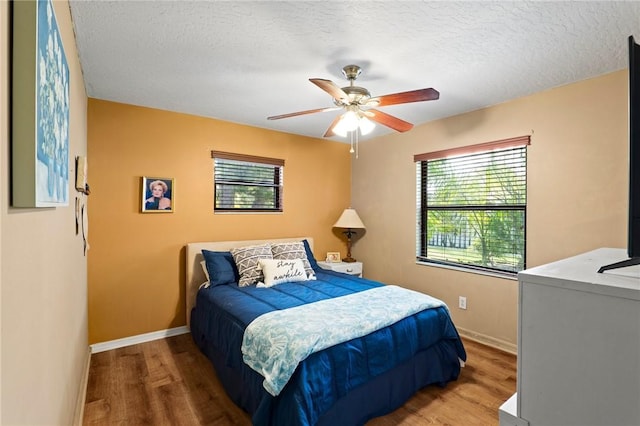 2033 Thistle Dr, Melbourne, FL 32935 - bedroom with baseboards, a textured ceiling, ceiling fan, and wood finished floors