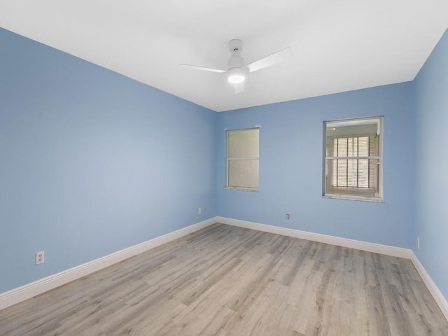 empty room with light wood-type flooring, ceiling fan, and baseboards