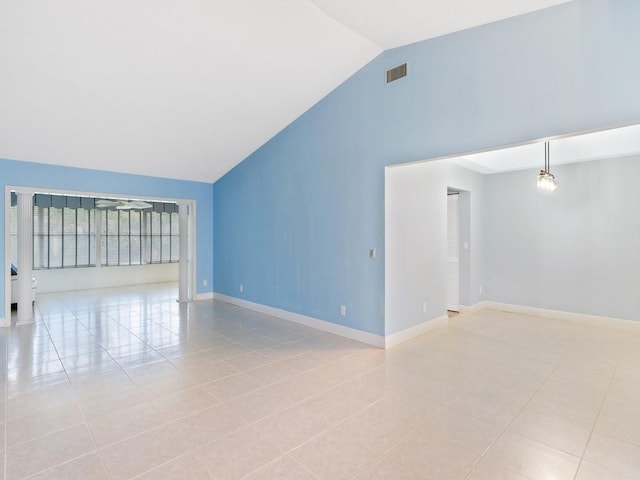 empty room featuring high vaulted ceiling, visible vents, baseboards, and light tile patterned flooring