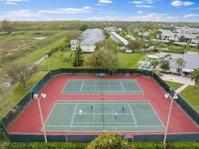 view of tennis court featuring a residential view