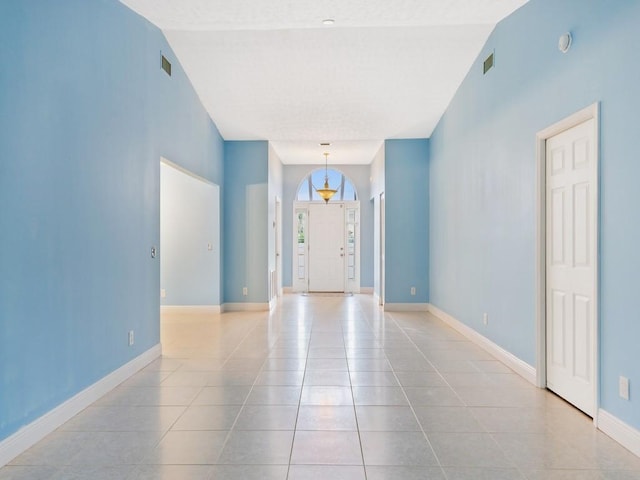 interior space featuring light tile patterned floors and baseboards