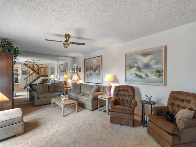 living room featuring light carpet, a textured ceiling, and ceiling fan