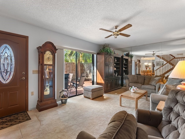 tiled living room featuring ceiling fan and a textured ceiling