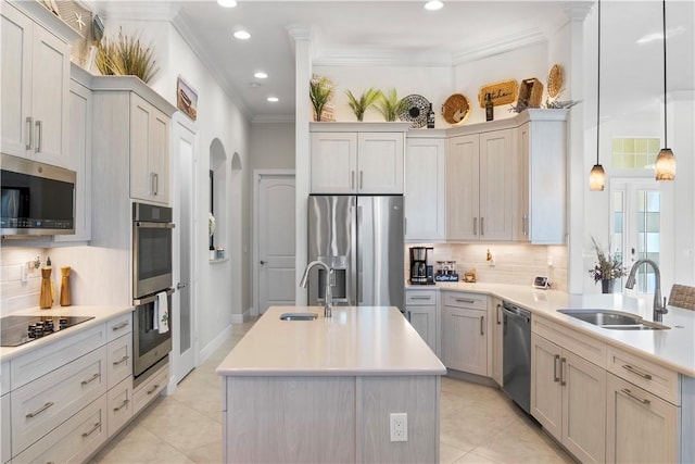 kitchen with stainless steel appliances, light countertops, a sink, and ornamental molding