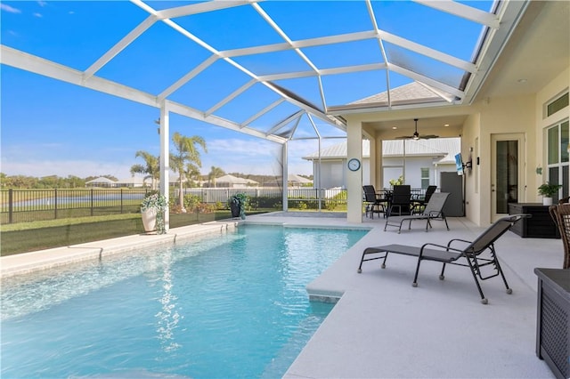 view of pool featuring ceiling fan, a lanai, fence, a fenced in pool, and a patio area