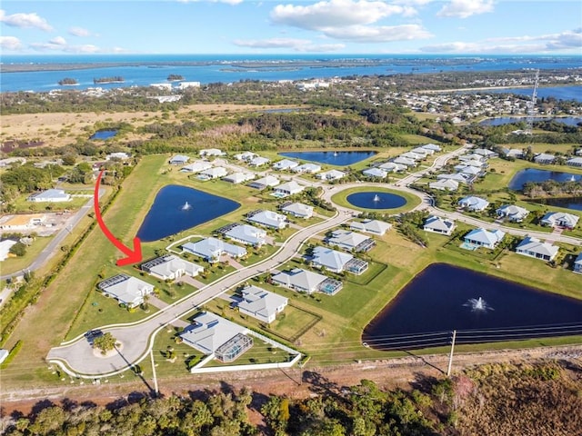 birds eye view of property with a water view and a residential view