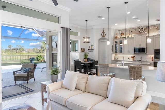 living area with light tile patterned floors, recessed lighting, a chandelier, and crown molding