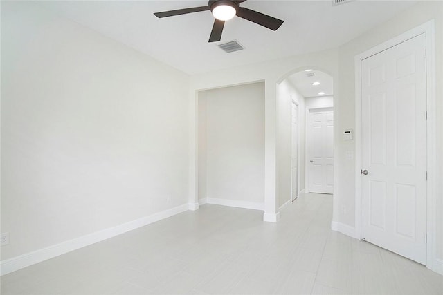 1819 Oak Grove Ct, Vero Beach, FL 32966 - spare room with arched walkways, a ceiling fan, and baseboards