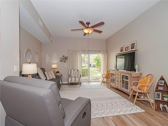 living room featuring hardwood / wood-style floors and ceiling fan