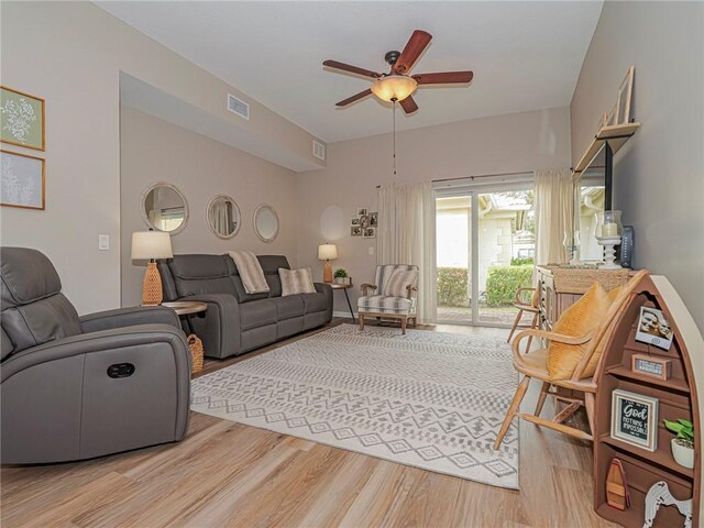 living room featuring ceiling fan and hardwood / wood-style floors