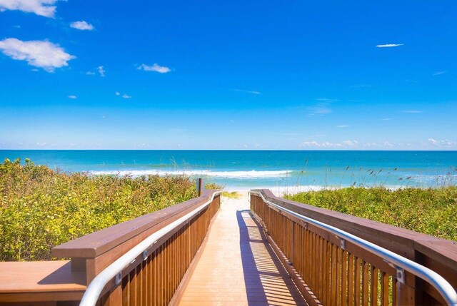 view of community with a view of the beach and a water view