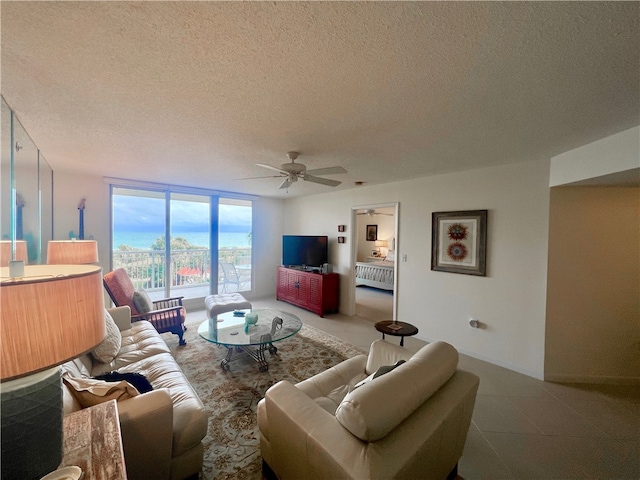 living room featuring floor to ceiling windows, a textured ceiling, and ceiling fan