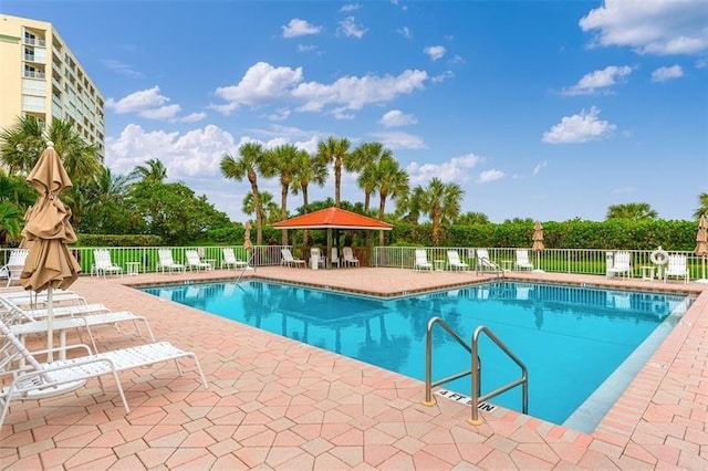 view of swimming pool featuring a patio and a gazebo