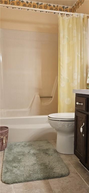 full bathroom with toilet, shower / bath combo, vanity, and tile patterned floors