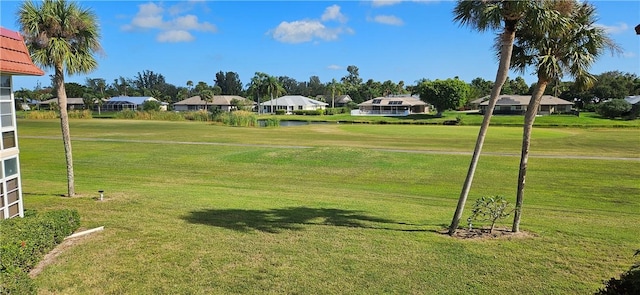 surrounding community with a lawn and a water view