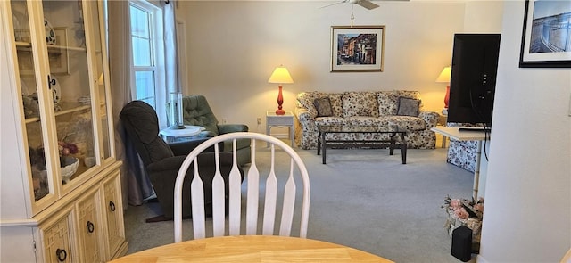 interior space with carpet floors and ceiling fan