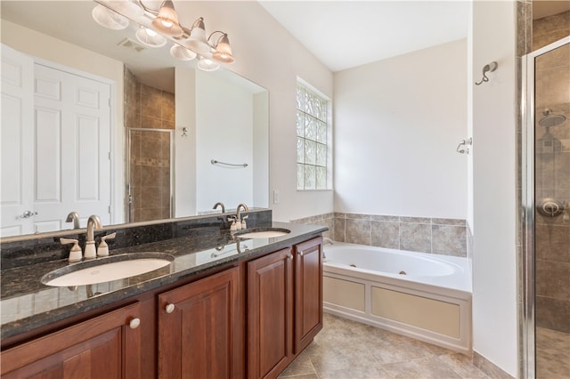 bathroom with a garden tub, double vanity, a sink, and visible vents