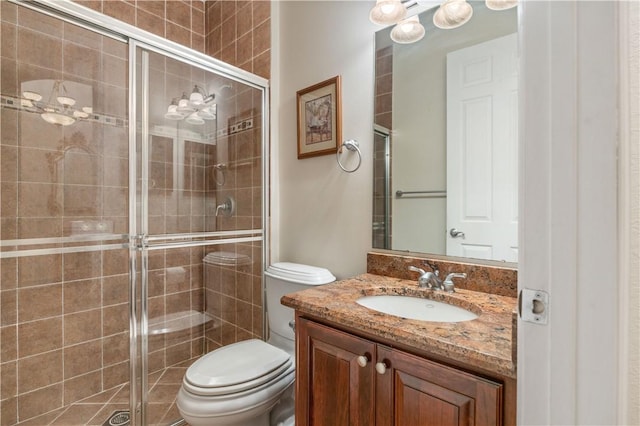 full bath with a shower stall, vanity, and toilet