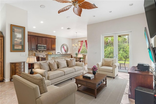 living room featuring light tile patterned floors, recessed lighting, ceiling fan with notable chandelier, visible vents, and french doors