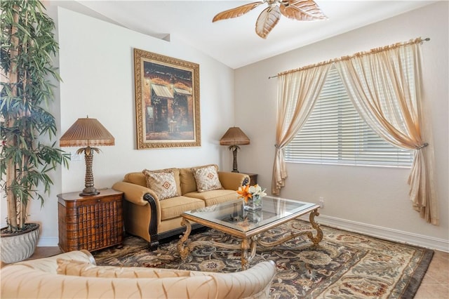 living area featuring lofted ceiling, ceiling fan, and baseboards