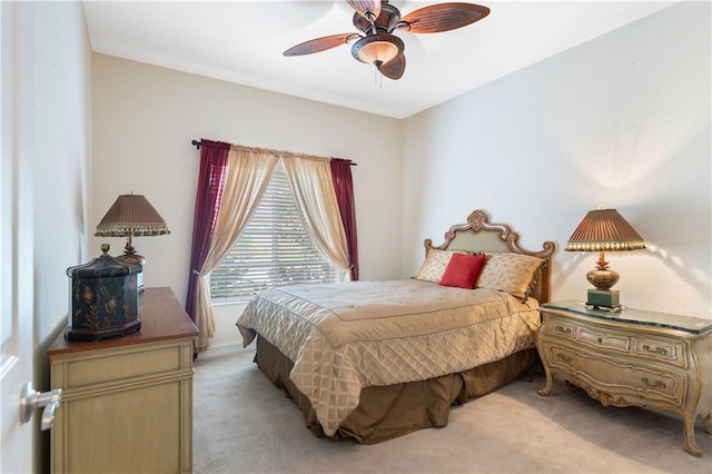 bedroom featuring light carpet and ceiling fan