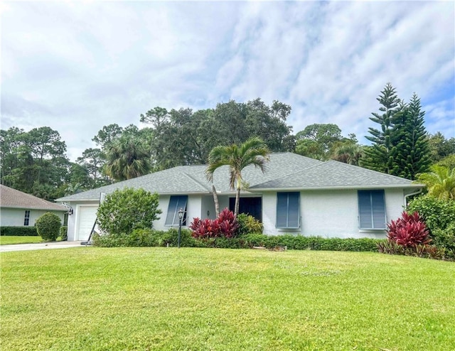 single story home with a front yard and a garage