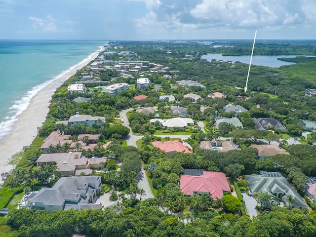 drone / aerial view featuring a view of the beach and a water view