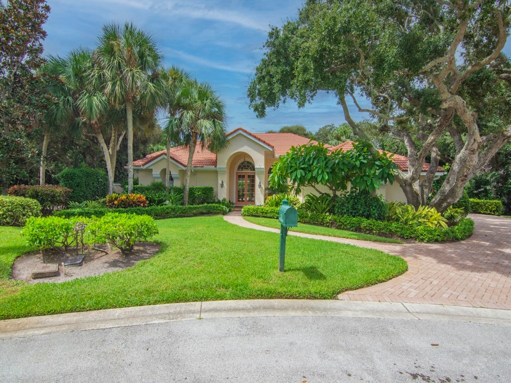 mediterranean / spanish home with a front yard