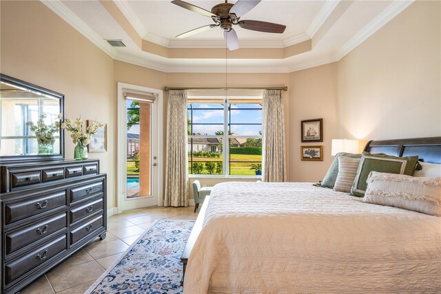 tiled bedroom featuring ceiling fan, a raised ceiling, crown molding, and access to outside