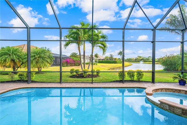 view of pool with a lanai, an in ground hot tub, and a yard