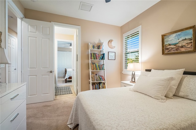 bedroom with light colored carpet and ceiling fan